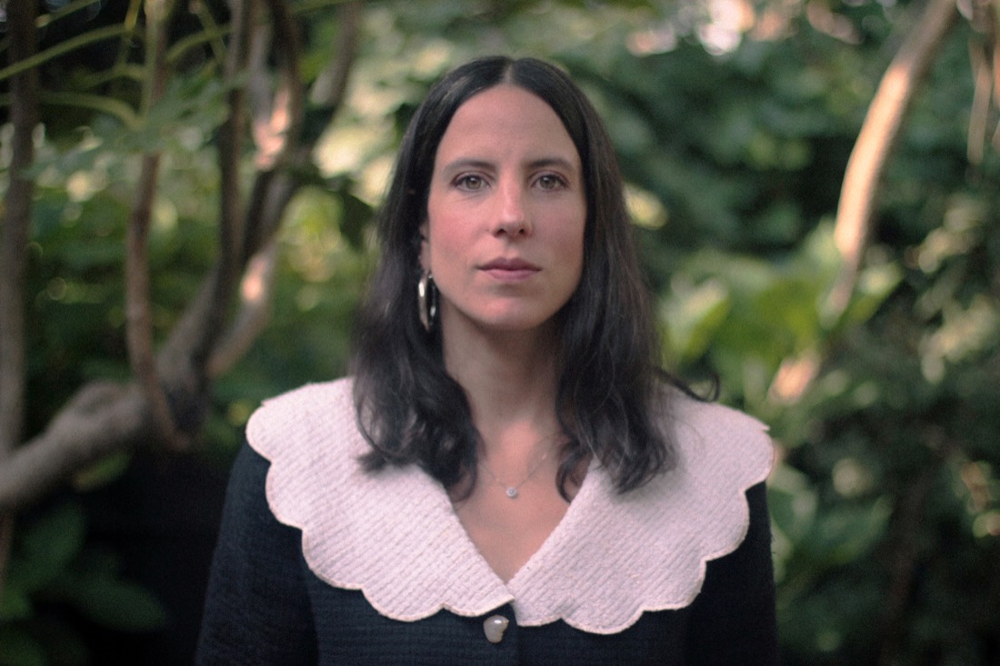 María Angélica Madero, photographed outdoors among foliage.